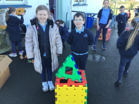 P.5 children helping P2/3 with their 3D shape building